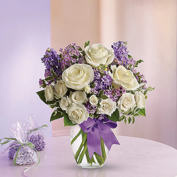 white roses and purple flowers in a vase