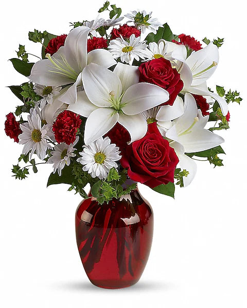red and white flowers in a red vase