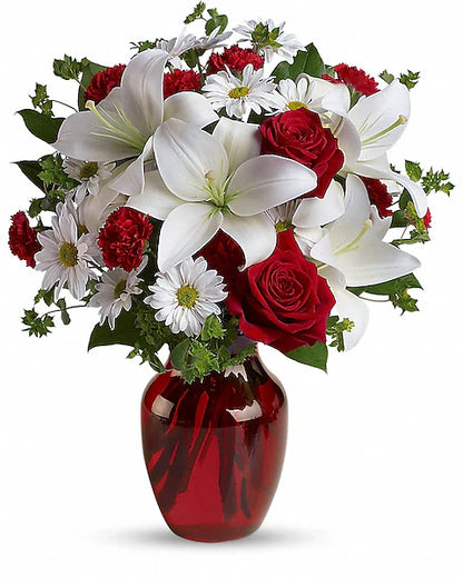 red and white flowers in a red vase