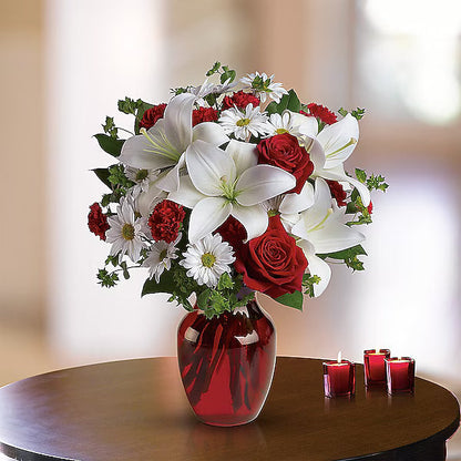 Bouquet of red and white flowers in a red vase