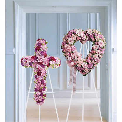 Floral cross and heart-shaped wreath on stands