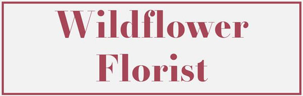 Wildflower Florist logo with a pink border on a white background